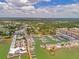 Aerial view of a bustling harbor community with a mix of residential buildings and recreational boating docks at 1841 Douglas Ave, Dunedin, FL 34698