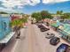 Vibrant street view with colorful buildings, mature trees, and easy access to street parking in a charming commercial district at 1841 Douglas Ave, Dunedin, FL 34698