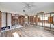 Open-concept living room showcasing wood-look flooring and exposed wall studs at 1841 Douglas Ave, Dunedin, FL 34698