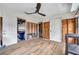 Updated wood-look flooring with exposed framing, doors to the backyard and the garage at 1841 Douglas Ave, Dunedin, FL 34698