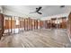 Spacious living room featuring new wood-look floors and a modern ceiling fan at 1841 Douglas Ave, Dunedin, FL 34698