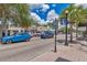 A bustling street view with colorful storefronts, sidewalk, street parking and local shops in a walkable area at 1841 Douglas Ave, Dunedin, FL 34698