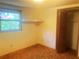 Standard bedroom with a window view, closet, and basic finishes at 20989 Negril, Lutz, FL 33558
