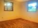 Neutral bedroom featuring tan carpet, two windows, and bright natural light at 20989 Negril, Lutz, FL 33558
