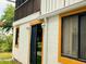 Close up view of a light colored home showing sliding glass doors with orange trim at 20989 Negril, Lutz, FL 33558