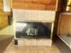 The fireplace has tile surrounding it, with a vintage hearth and glass doors at 20989 Negril, Lutz, FL 33558