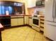 This kitchen features tile floors, appliances, and an open window to another room at 20989 Negril, Lutz, FL 33558