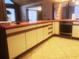 This kitchen features bright counters, tile floors, and white cabinets at 20989 Negril, Lutz, FL 33558