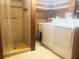 This laundry room has tile flooring, a shower, a sink, and a washer and dryer at 20989 Negril, Lutz, FL 33558