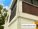 Exterior view of a second-story screened-in balcony and white rain gutters at 20989 Negril, Lutz, FL 33558