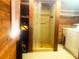 This shower features wood paneling, vinyl flooring, and a view of a large storage closet at 20989 Negril, Lutz, FL 33558
