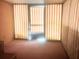 A bright sunroom featuring striped privacy screens and carpeted floors at 20989 Negril, Lutz, FL 33558