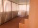 Carpeted sunroom with striped privacy screens and built-in wooden shelves at 20989 Negril, Lutz, FL 33558