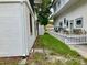 Green grass side yard and a partial view of a white picket fence create a serene and private outdoor space at 20989 Negril, Lutz, FL 33558