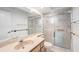 Bathroom featuring a large mirror, tile floor, updated vanity, and a glass enclosed shower at 2222 Westchester Blvd, Spring Hill, FL 34606