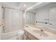 Bright bathroom with neutral tones, tile floor, updated vanity, and a shower-tub combination at 2222 Westchester Blvd, Spring Hill, FL 34606