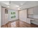 Bright bedroom featuring custom built-ins, wood floors, and ample natural light at 2222 Westchester Blvd, Spring Hill, FL 34606
