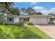 Charming home with stone accents, brick driveway, and well-manicured lawn at 2222 Westchester Blvd, Spring Hill, FL 34606