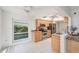 Galley kitchen featuring stainless appliances, granite countertops, and a window overlooking lush greenery at 2222 Westchester Blvd, Spring Hill, FL 34606
