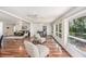 Open living room and dining area with hardwood floors, multiple windows, and comfortable seating at 2222 Westchester Blvd, Spring Hill, FL 34606