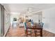 Spacious living room with hardwood floors, a ceiling fan, and an open floor plan into the dining area at 2222 Westchester Blvd, Spring Hill, FL 34606