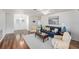 Inviting living area featuring a stylish sofa, hardwood floors and bright lighting at 2222 Westchester Blvd, Spring Hill, FL 34606