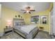 A bedroom with a full sized bed, ceiling fan and neutral paint color and light gray carpeting at 2329 Carrie Ct, Dunedin, FL 34698