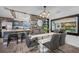 Bright dining room boasts a modern glass table and a clear view of the kitchen and living area with a brick fireplace at 2329 Carrie Ct, Dunedin, FL 34698