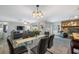 Open concept dining room showcasing a glass table and chairs with views of the living room and fireplace at 2329 Carrie Ct, Dunedin, FL 34698