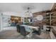 Dining room adjacent to the open floor plan with a modern chandelier and a view of the fireplace at 2329 Carrie Ct, Dunedin, FL 34698