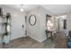Bright foyer with tile floors, a stylish mirror, and a table with a lamp and a potted plant at 2329 Carrie Ct, Dunedin, FL 34698