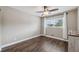 Bedroom features hardwood floors, window with bright, natural light and a ceiling fan at 2461 Rhodesian Dr # 47, Clearwater, FL 33763
