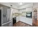 Kitchen with white cabinetry, stainless steel appliances, and hardwood flooring at 2461 Rhodesian Dr # 47, Clearwater, FL 33763