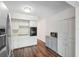 Bright kitchen with stainless steel refrigerator, hardwood floors, and updated countertops at 2461 Rhodesian Dr # 47, Clearwater, FL 33763