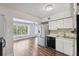 Well-lit kitchen with stainless steel appliances, hardwood floors, and ample natural light at 2461 Rhodesian Dr # 47, Clearwater, FL 33763