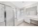 Bright bathroom with a glass-enclosed shower, garden tub, and vanity with marble countertop at 25101 Hyde Park Blvd, Land O Lakes, FL 34639