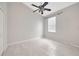 Neutral bedroom with tiled floors, ceiling fan, natural lighting, and a minimalist aesthetic at 25101 Hyde Park Blvd, Land O Lakes, FL 34639