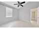 Clean and bright bedroom offering tiled floors, large window, and ceiling fan at 25101 Hyde Park Blvd, Land O Lakes, FL 34639