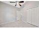 Bright bedroom featuring tile floors, ceiling fan, and closet at 25101 Hyde Park Blvd, Land O Lakes, FL 34639