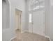 Bright foyer features a tiled floor, high ceilings, and a window above the white front door at 25101 Hyde Park Blvd, Land O Lakes, FL 34639
