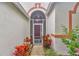 Close-up of the home's entryway, showing colorful plants and the front door at 25101 Hyde Park Blvd, Land O Lakes, FL 34639