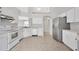 Bright kitchen with white cabinets, stainless appliances, and tiled floors at 25101 Hyde Park Blvd, Land O Lakes, FL 34639