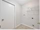 Functional laundry room with shelving and hookups for a washer and dryer at 25101 Hyde Park Blvd, Land O Lakes, FL 34639
