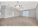 Spacious living room features tiled floors, a ceiling fan, and sliding glass doors at 25101 Hyde Park Blvd, Land O Lakes, FL 34639