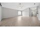 Spacious living room features tiled floors, a ceiling fan, and lots of natural light at 25101 Hyde Park Blvd, Land O Lakes, FL 34639
