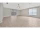 This spacious living room features tiled floors, a ceiling fan, and sliding doors at 25101 Hyde Park Blvd, Land O Lakes, FL 34639