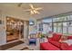 Bright sunroom featuring comfortable seating and walls of windows for scenic views at 25101 Hyde Park Blvd, Land O Lakes, FL 34639