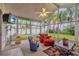 Relaxing sunroom with cozy seating, ceiling fan and sliding windows for natural light and air at 25101 Hyde Park Blvd, Land O Lakes, FL 34639