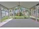Bright sunroom with many windows offering views of tropical landscaping at 25101 Hyde Park Blvd, Land O Lakes, FL 34639