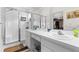 Bright bathroom with double vanity, a walk-in shower, and a view to the walk-in closet at 26343 Whirlaway Ter, Wesley Chapel, FL 33544